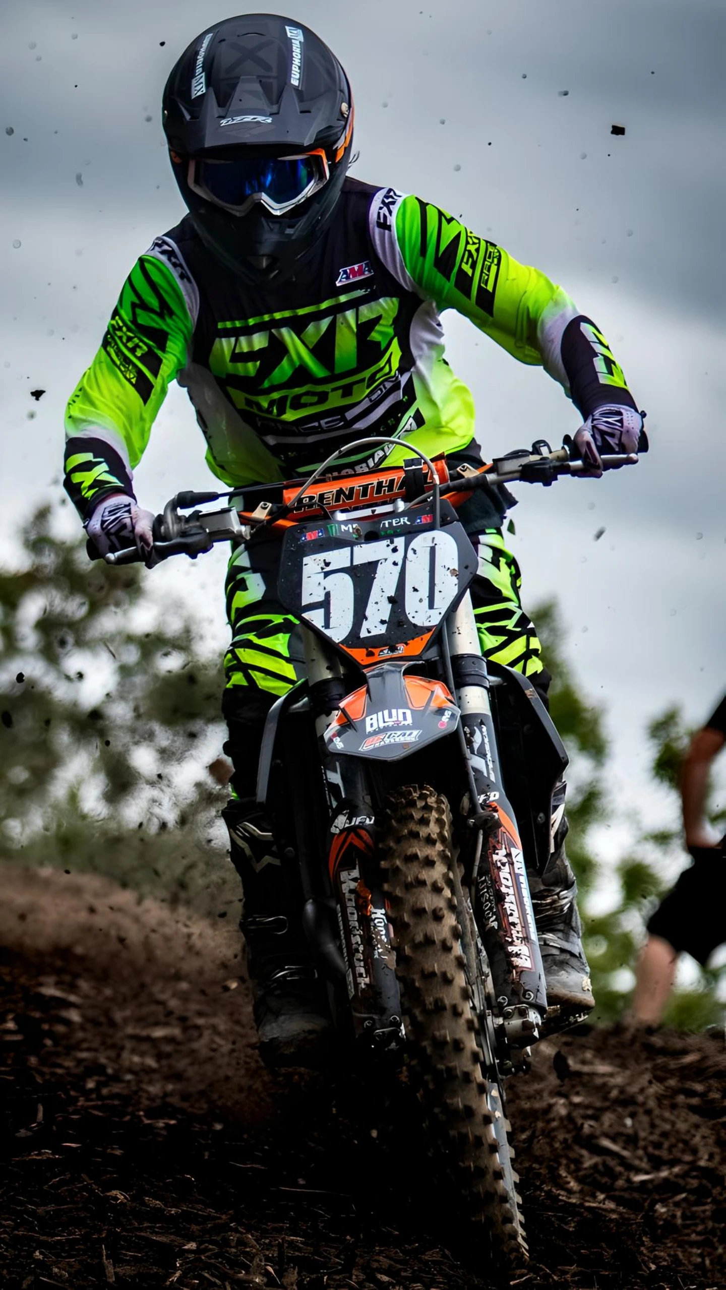 Dynamic shot of motocross rider on bike number 570 kicking up dirt.